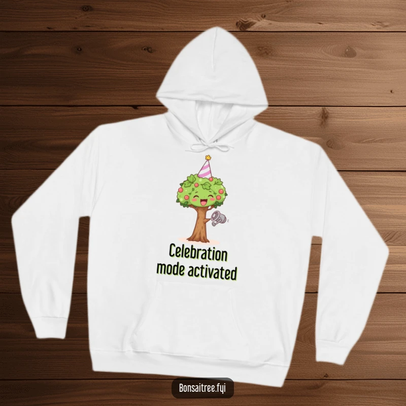 Funny hoodie showing a happy bonsai tree in a party hat, dancing energetically with a watering can.