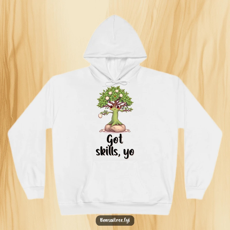 Funny Bonsai Tree Hoodie: A talented bonsai character skillfully juggling tiny pebbles with its branches, perfect for fans of dexterity.