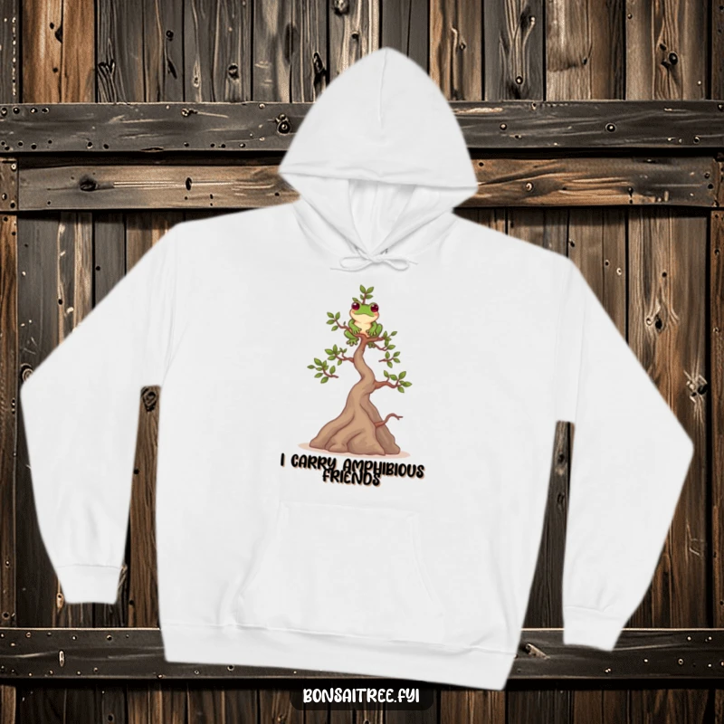 Funny hoodie depicting a playful bonsai tree character balancing a frog on its top branch. Comfortable and amusing.