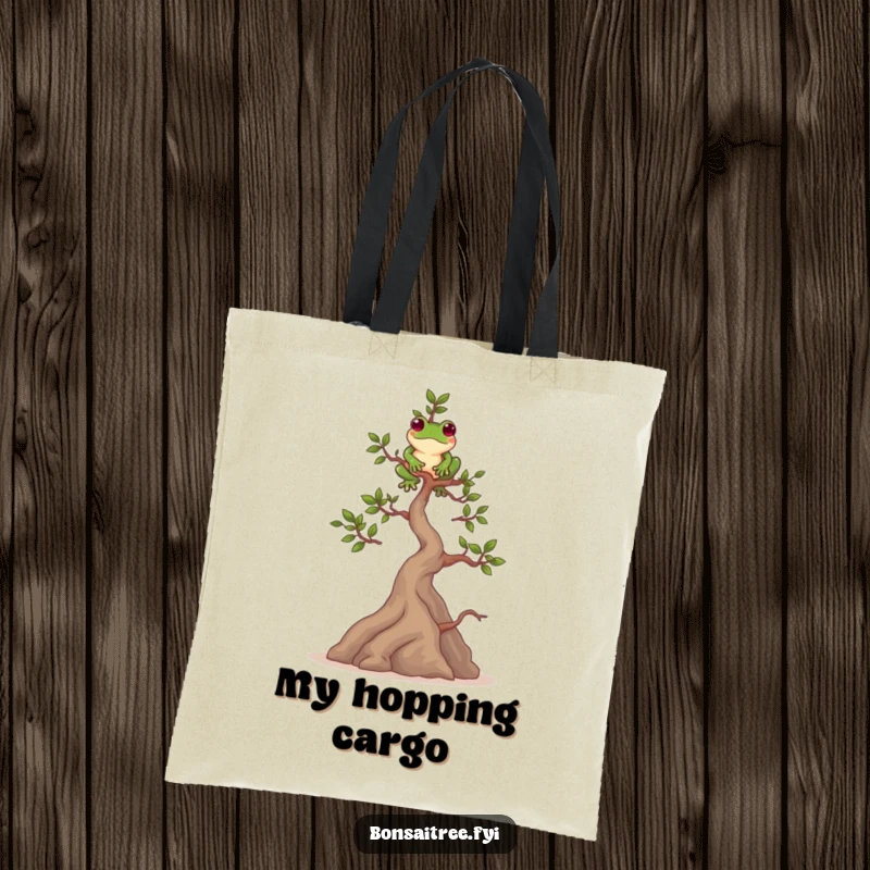 Funny tote bag featuring a playful bonsai tree character balancing a frog on its highest branch. A unique and charming accessory.